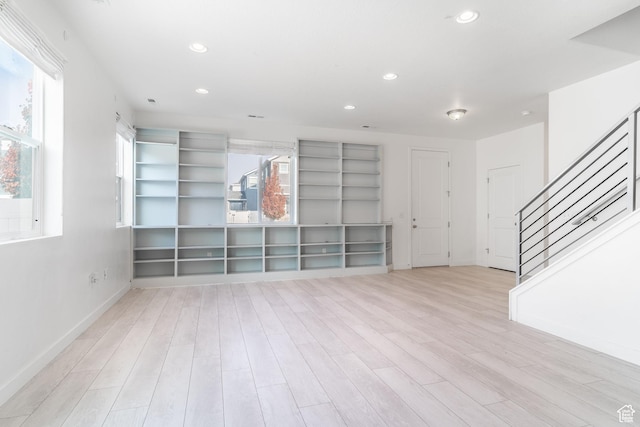 unfurnished living room featuring light hardwood / wood-style flooring and a healthy amount of sunlight