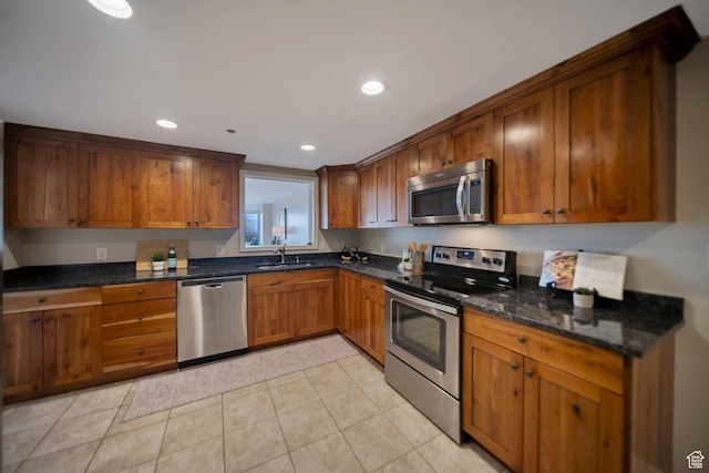 44 W 300 S Unit 2306S, Salt Lake City, UT 84101 - kitchen with appliances with stainless steel finishes, light tile patterned floors, dark stone counters, and sink