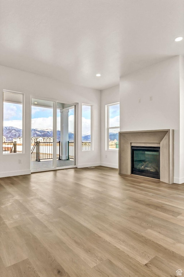 1854 S 1160 E Unit 406, Heber City, UT 84032 - unfurnished living room with a mountain view and light hardwood / wood-style flooring