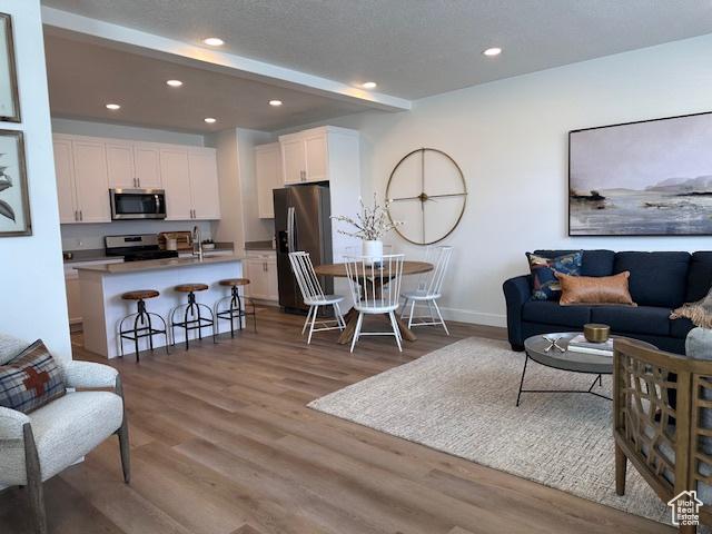 1056 E 1930 S Unit 420, Heber City, UT 84032 - living room with wood finished floors and recessed lighting