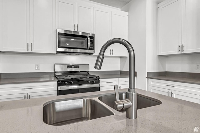1056 E 1930 S Unit 420, Heber City, UT 84032 - kitchen featuring stainless steel appliances, white cabinets, and dark stone countertops