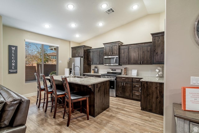 443 N Puerta Dr, Washington, UT 84780 - kitchen with a center island with sink, a kitchen breakfast bar, lofted ceiling, and stainless steel appliances