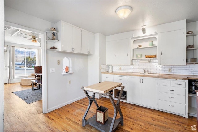38 S State St W, Fairview, UT 84629 - kitchen with white cabinetry, ceiling fan, butcher block countertops, backsplash, and light wood-type flooring