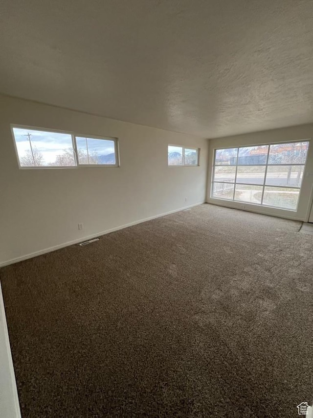 220 S 100 E, Tooele, UT 84074 - carpeted empty room with baseboards and a textured ceiling