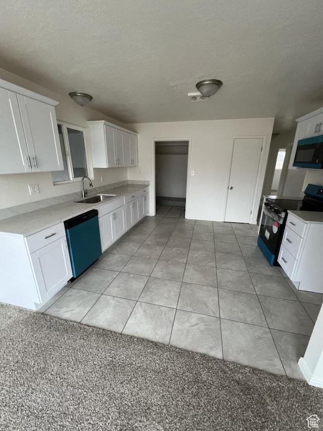 220 S 100 E, Tooele, UT 84074 - kitchen with stainless steel electric range oven, dishwasher, black microwave, white cabinets, and a textured ceiling