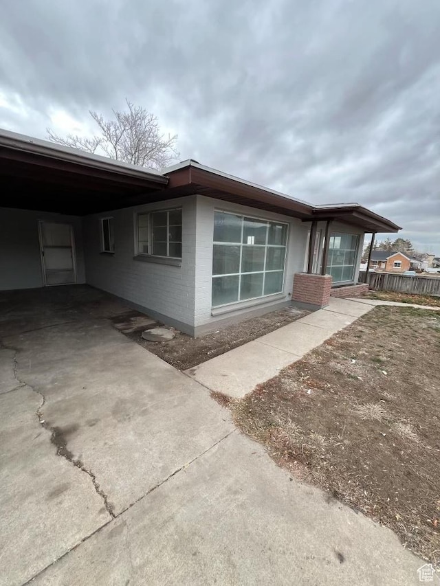 220 S 100 E, Tooele, UT 84074 - view of home's exterior featuring an attached carport and brick siding