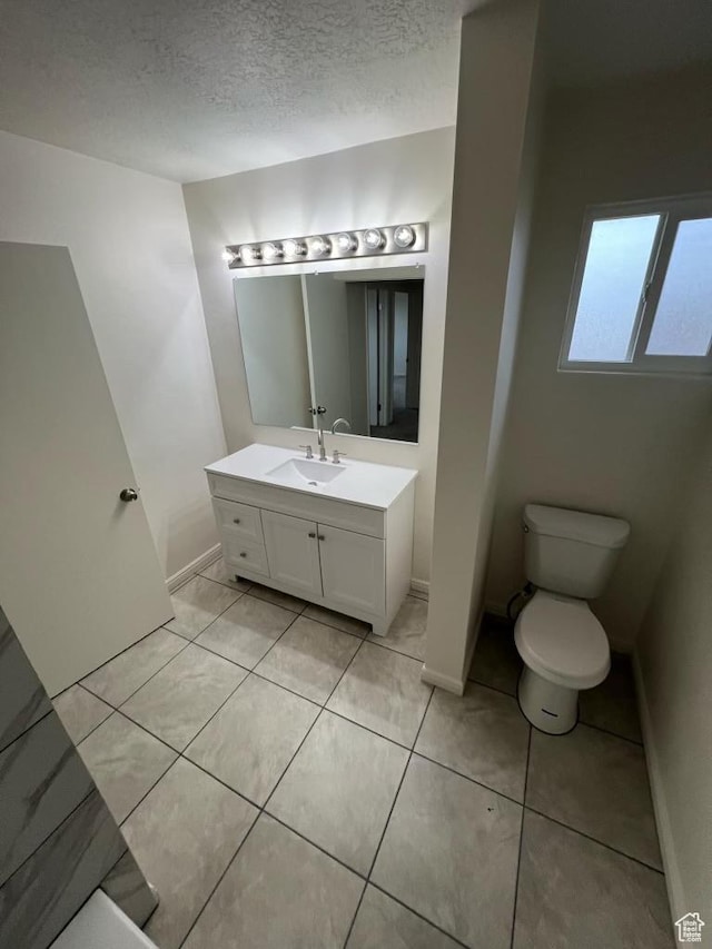 220 S 100 E, Tooele, UT 84074 - bathroom featuring vanity, a textured ceiling, and tile patterned floors