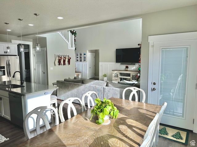 6057 W Herriman View Way S, Herriman, UT 84096 - dining area featuring wainscoting, dark wood-style flooring, a textured ceiling, and recessed lighting