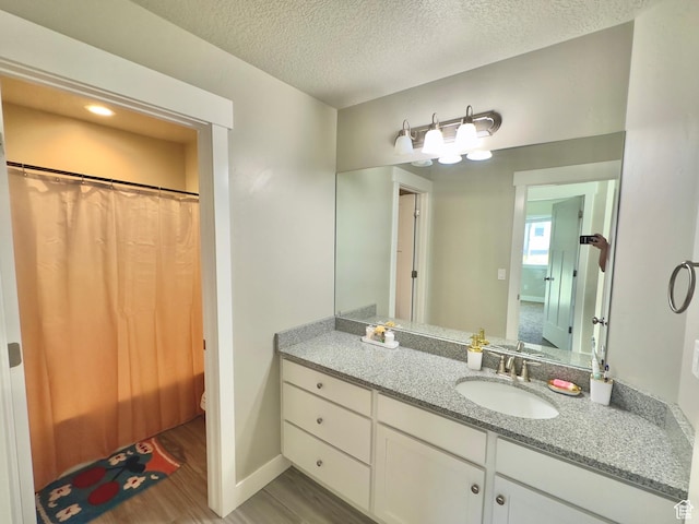 6057 W Herriman View Way S, Herriman, UT 84096 - full bathroom featuring a textured ceiling, baseboards, wood finished floors, curtained shower, and vanity