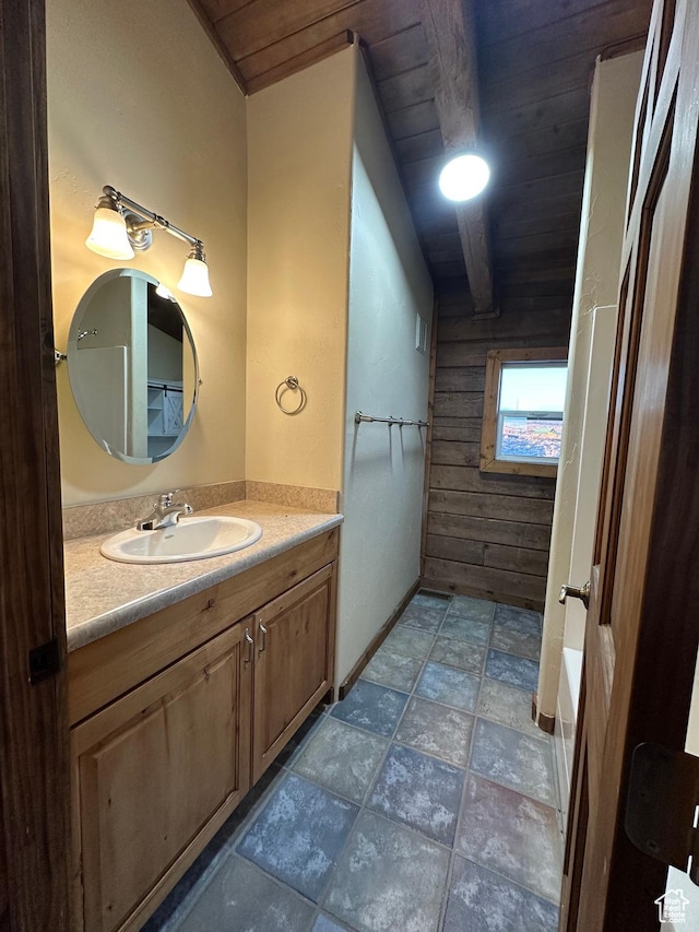 bathroom featuring vanity, wooden walls, and wooden ceiling