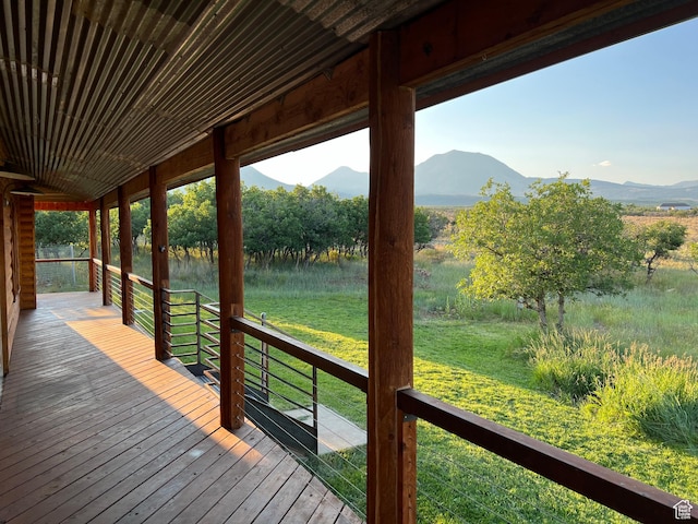 wooden deck featuring a mountain view and a rural view