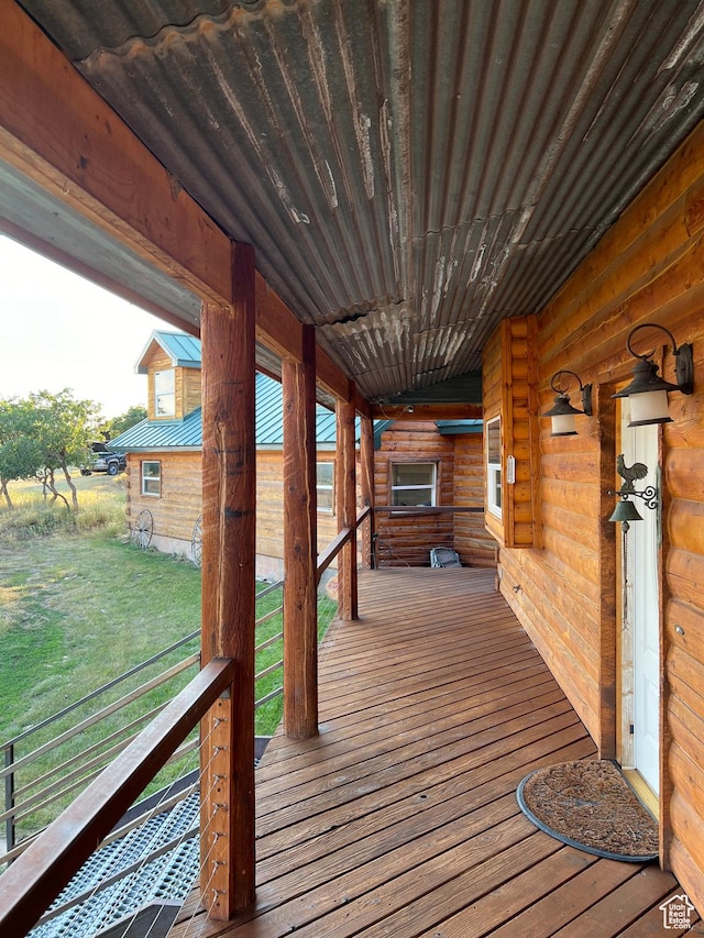 wooden terrace featuring covered porch