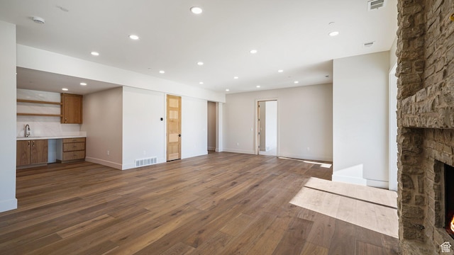 2072 E Copper Belt Dr, Heber City, UT 84032 - unfurnished living room with dark hardwood / wood-style flooring, sink, built in desk, and a fireplace