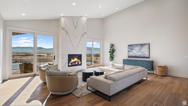 2072 E Copper Belt Dr, Heber City, UT 84032 - living room with a mountain view, wood-type flooring, a fireplace, and a wealth of natural light