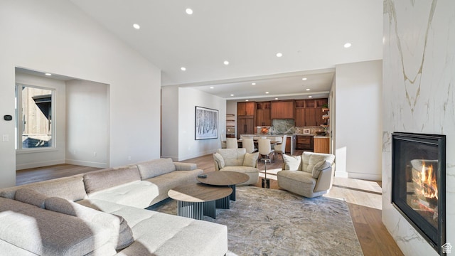 2072 E Copper Belt Dr, Heber City, UT 84032 - living room featuring a premium fireplace, high vaulted ceiling, and light wood-type flooring