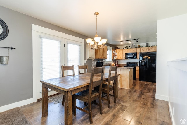 2814 S 1150 W, Nibley, UT 84321 - dining room featuring a chandelier, baseboards, rail lighting, and dark wood finished floors