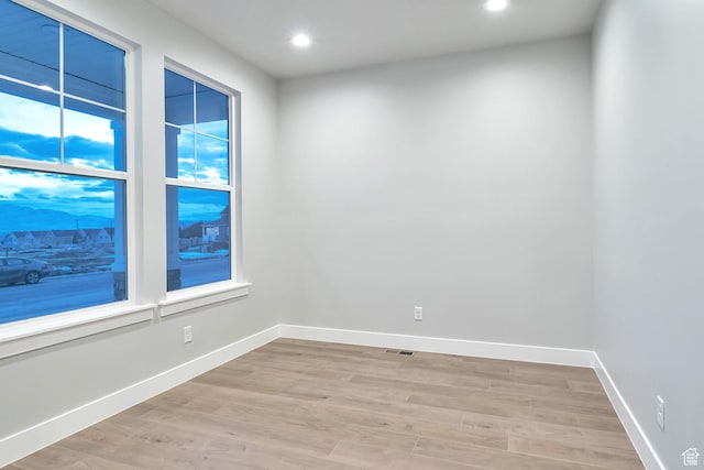 unfurnished room with baseboards, visible vents, recessed lighting, and light wood finished floors