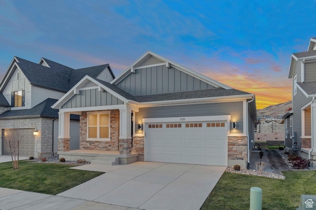 craftsman-style house with concrete driveway, stone siding, board and batten siding, a front lawn, and a garage