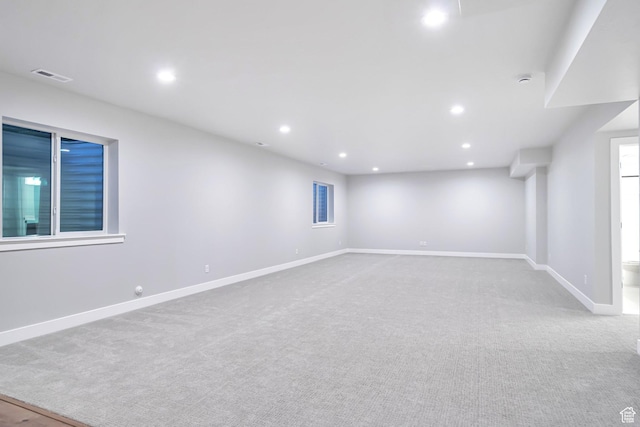 below grade area featuring baseboards, carpet floors, visible vents, and recessed lighting