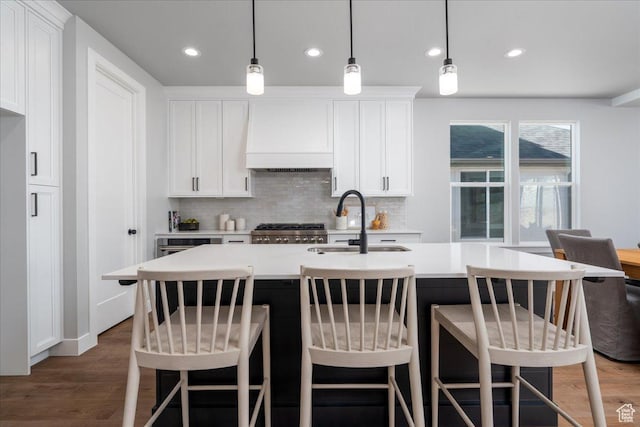 1136 W 2980 N, Lehi, UT 84043 - kitchen with custom range hood, wood finished floors, backsplash, light countertops, and recessed lighting