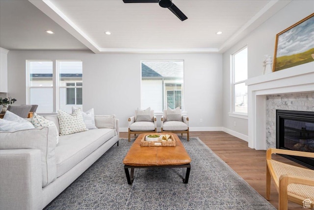 living area with a high end fireplace, baseboards, ceiling fan, wood finished floors, and recessed lighting