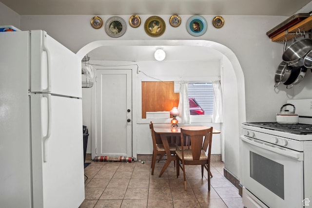 kitchen with light tile patterned floors and white appliances