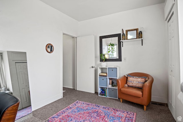 living area with dark carpet