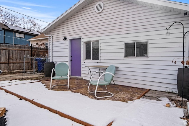 view of snow covered rear of property