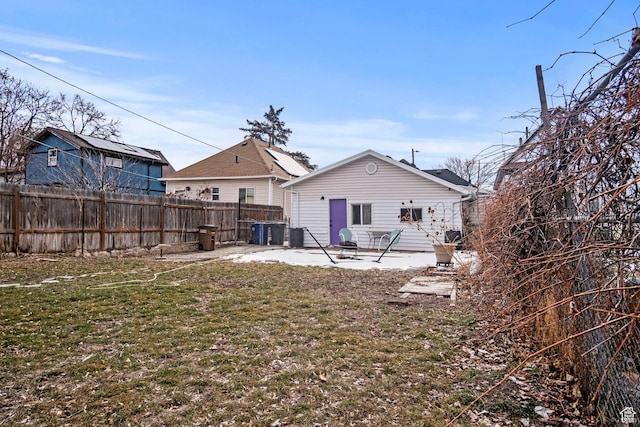 rear view of house with a patio and a lawn