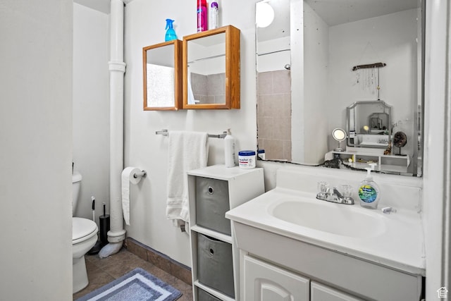 bathroom with tile patterned flooring, vanity, and toilet