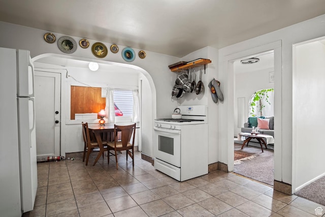 kitchen featuring white appliances and light tile patterned flooring
