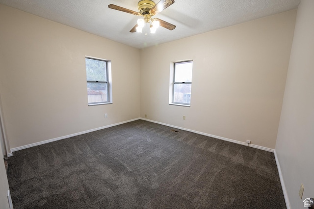 carpeted empty room with ceiling fan and a textured ceiling