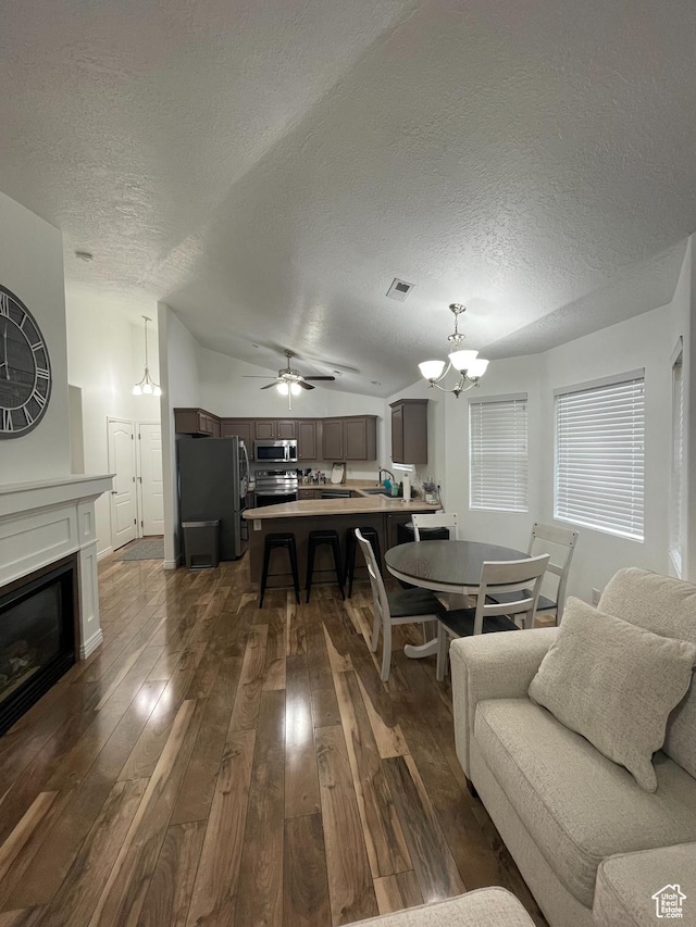 1715 W Westbury Way Unit Z12, Lehi, UT 84043 - living room featuring ceiling fan with notable chandelier, dark hardwood / wood-style flooring, a textured ceiling, and vaulted ceiling