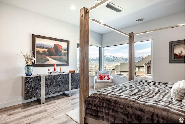 bedroom featuring a mountain view and light hardwood / wood-style floors