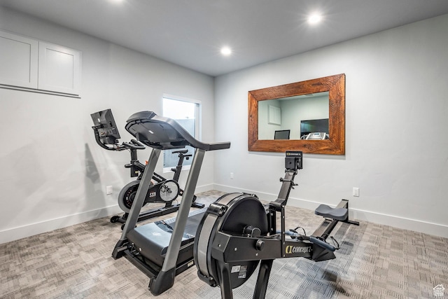 exercise area featuring light colored carpet