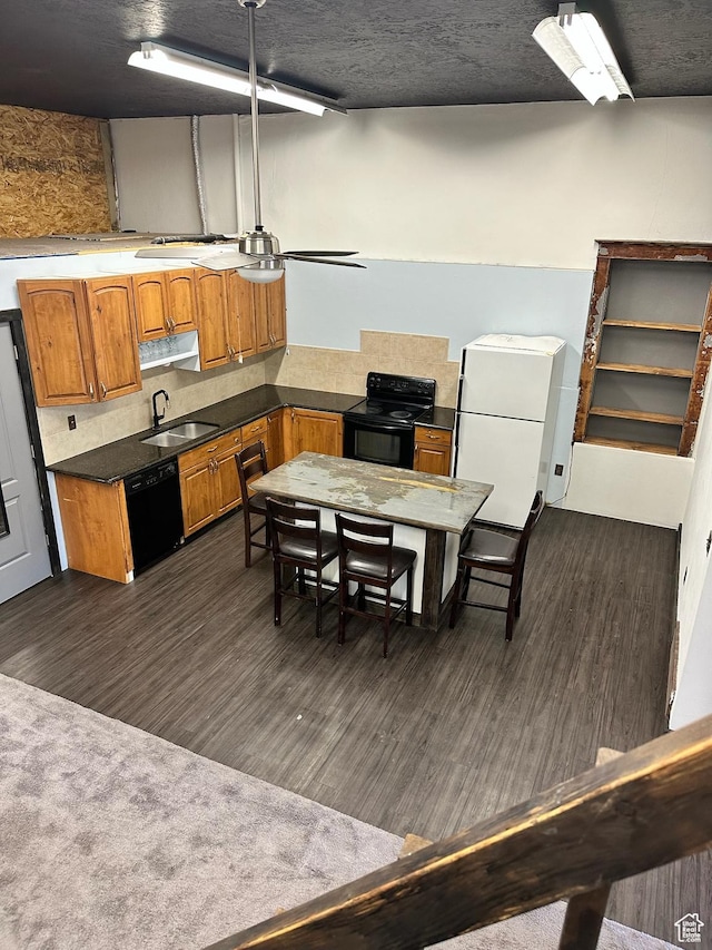 45 W Main St, Moroni, UT 84646 - kitchen featuring black appliances, decorative backsplash, sink, and dark wood-type flooring