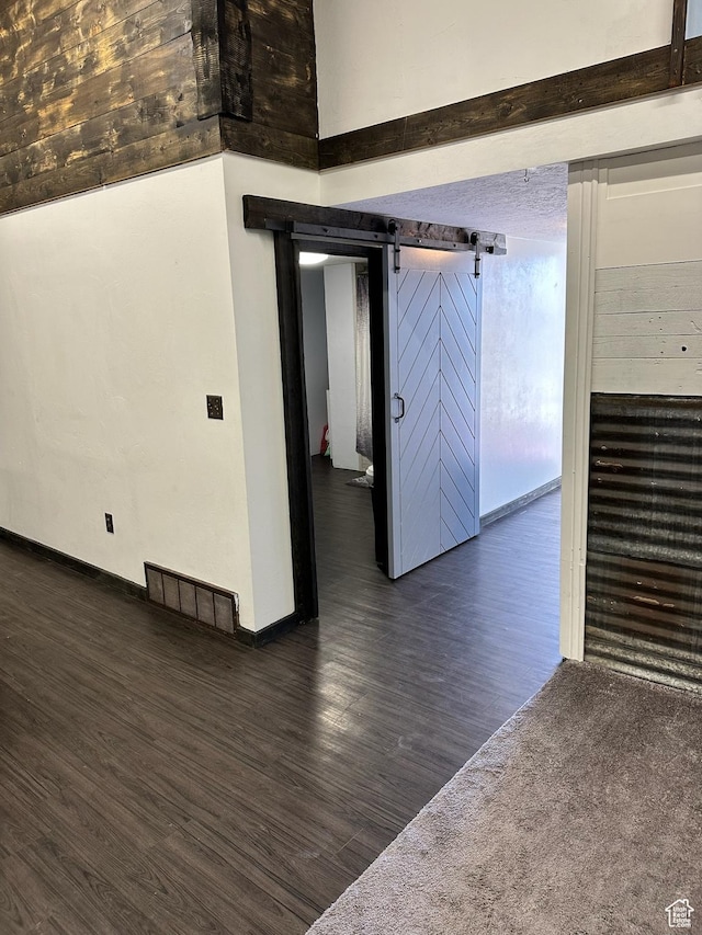 45 W Main St, Moroni, UT 84646 - spare room featuring a barn door and dark hardwood / wood-style flooring