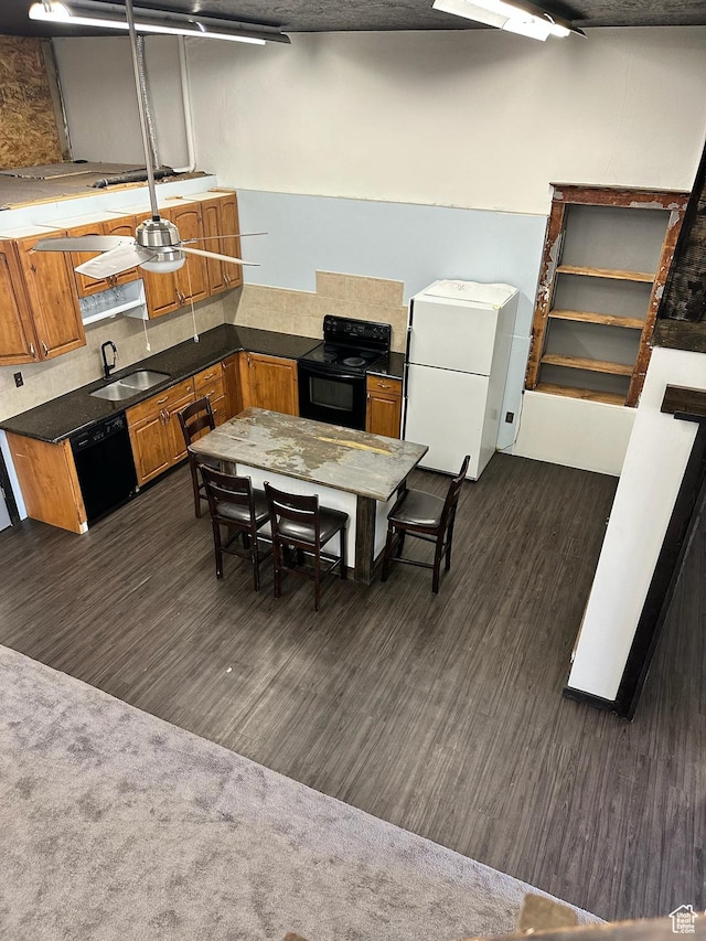 45 W Main St, Moroni, UT 84646 - kitchen with sink, dark wood-type flooring, and black appliances