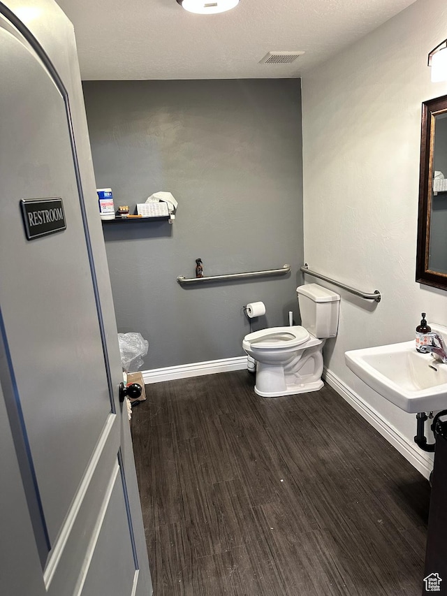 45 W Main St, Moroni, UT 84646 - bathroom with hardwood / wood-style floors, toilet, and sink
