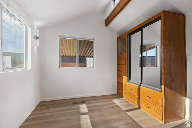 1160 E Telegraph St Unit 4, Washington, UT 84780 - unfurnished bedroom featuring lofted ceiling with beams and light hardwood / wood-style flooring