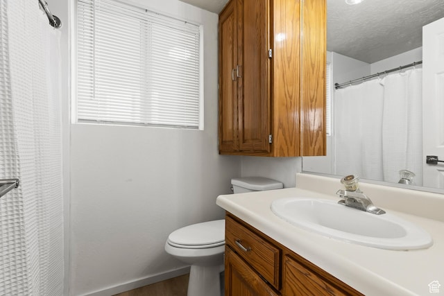 1160 E Telegraph St Unit 4, Washington, UT 84780 - bathroom featuring vanity, a textured ceiling, toilet, and a healthy amount of sunlight