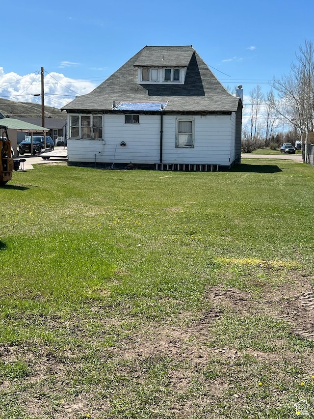 340 Jefferson St, Montpelier, ID 83254 - back of property with a yard and roof with shingles
