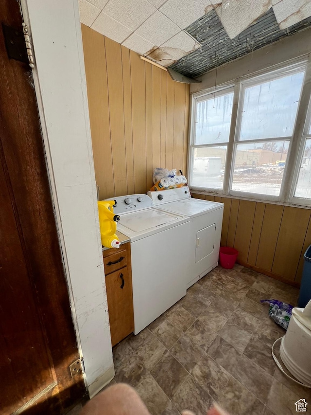 340 Jefferson St, Montpelier, ID 83254 - laundry room featuring wood walls and washing machine and dryer