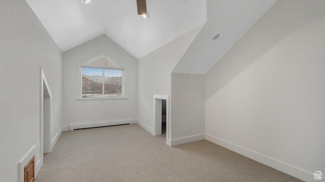 additional living space with ceiling fan, lofted ceiling, light carpet, and a baseboard radiator