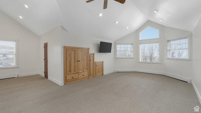 unfurnished living room featuring light carpet, a wealth of natural light, a baseboard radiator, and ceiling fan