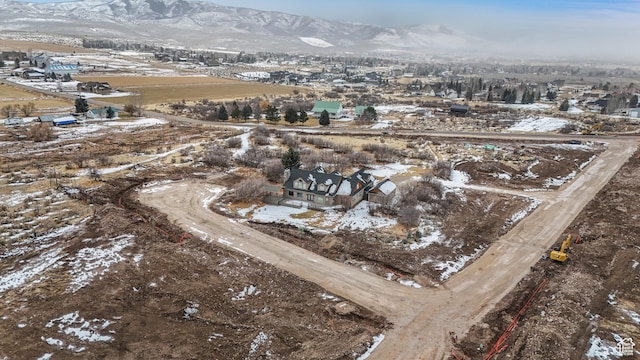 snowy aerial view with a mountain view