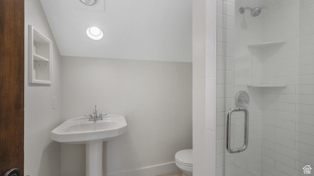 bathroom featuring an enclosed shower, vaulted ceiling, and toilet