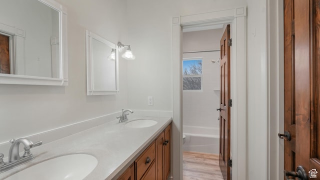 bathroom with vanity, wood-type flooring, and shower / bath combination