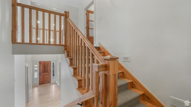 stairway with hardwood / wood-style flooring