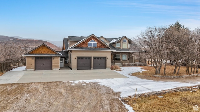view of front of property with a mountain view and a garage